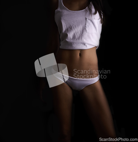 Image of Body, sexy and underwear with woman on black background in studio for feminine confidence. Skin, pajamas and wellness with stomach of model in panties for desire, fine art or sensuality in dark