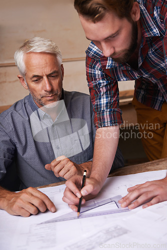 Image of Engineering, team and men with blueprint in workshop for building, construction or repairs. Architects, design and industrial apprentice planning and working on industry project with mentor.