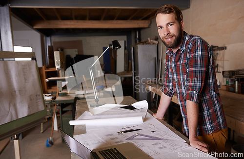 Image of Portrait, architect and man drawing up plans, documents and blueprint with ideas or planning for project. Face, entrepreneur or designer with paperwork or laptop with construction business or startup