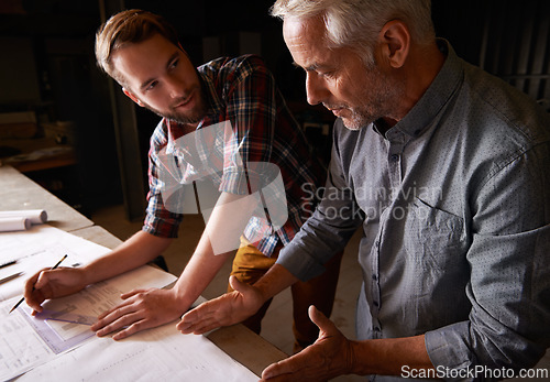 Image of Carpenter, team and men with blueprint for discussion of construction project or father teaching son. Engineer, apprentice and senior mentor with design, drawing and planning for training at workshop