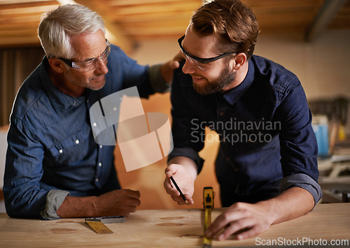 Image of Architecture, teamwork and senior mentoring man in workplace of workshop, pencil and drawing. Male people, professional and working with measuring tape on wooden table for planning of renovation