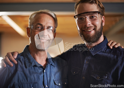 Image of Man, hug and smile with portrait, workshop and family business or apprenticeship. Mature father, son and embrace with artisan, carpentry and together for startup and mentor or learning with happiness