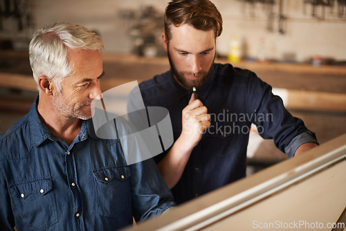 Image of Planning, discussion and architects by board in workshop for industrial carpentry project. Brainstorming, engineering and male industry apprentice working on ideas with mentor in office on site.