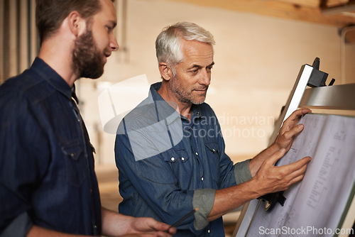 Image of Engineer, team and men with blueprint for planning project, construction and discussion. Architecture, apprentice and mentor with design, drawing and senior father with son for training at workshop