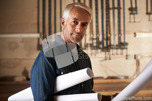 Image of Portrait, architect and senior man with blueprint, renovation and engineering in a workshop with construction. Face, entrepreneur and employee with documents and maintenance with business and startup