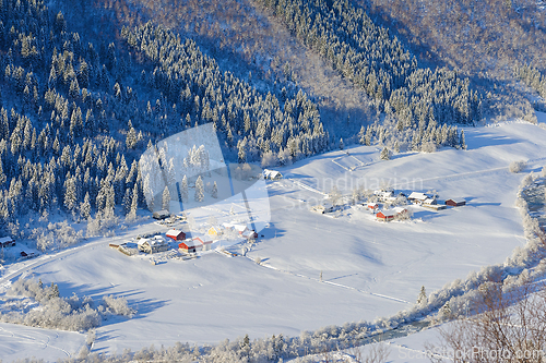 Image of Pristine winter wonderland in a mountainous village at dawn