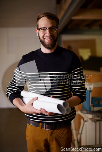 Image of Portrait, architect and man with blueprint, renovation and entrepreneur in a workshop with construction. Face, property and employee with documents and maintenance with startup, smile and business