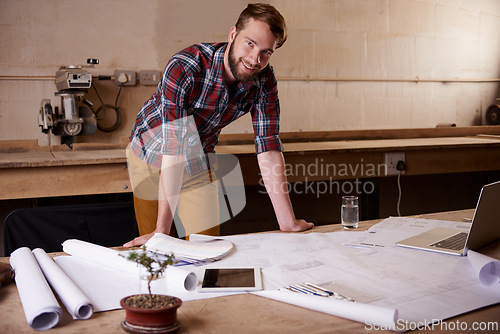 Image of Man, portrait and architect with blueprint for engineering or construction, renovation and design for building. Floor plan, sketch and property development with architecture paperwork in workshop