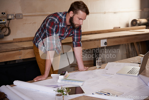 Image of Man, check blueprint and architect with engineering or construction, renovation project and design for building. Floor plan, sketch and property development with assessment of paperwork in workshop