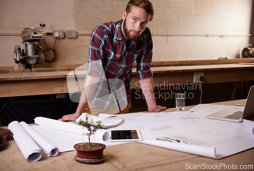 Image of Man, portrait and architect with floor plan for engineering or construction, renovation and design for building. Blueprint, sketch and property development with architecture paperwork in workshop