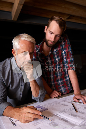 Image of Engineer, team and men with blueprint, thinking or plan for construction with serious father teaching son. Architecture, apprentice and senior mentor drawing design for problem solving in workshop