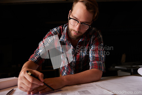 Image of Man, architect and table or paper, thinking and working on planning for construction. Architecture, building or engineering for infrastructure, design and contractor or career for remodel for measure