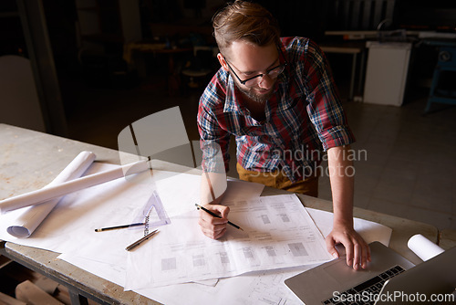 Image of Man, architect and laptop or blueprint, working and planning for construction. Architecture, building and engineering for infrastructure, design and contractor on technology for remodel research