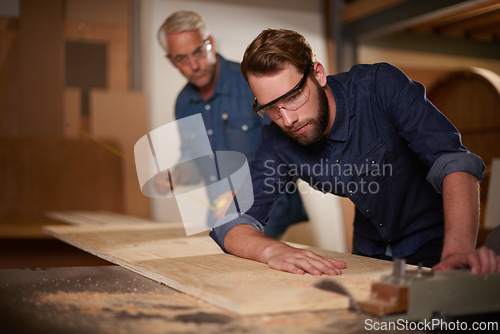 Image of Wood, father and son in a workshop, architect and carpenter with renovation or safety glasses with protection. Parent, men or teamwork with construction or building with planning for project or gear
