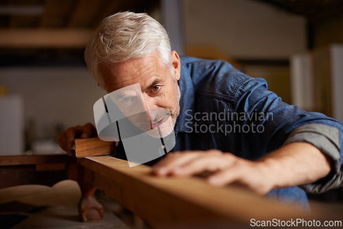 Image of Carpenter, mature man and wood for manufacturing in workshop, industry and company of construction. Entrepreneur, male person and professional in garage or shop for startup and small business