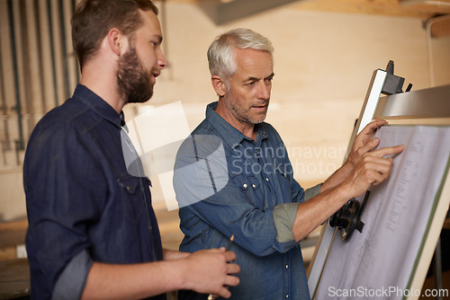 Image of Carpenter, team and men with blueprint for construction, planning project and creative. Architecture, apprentice and mentor with design, drawing and senior father with son for training at workshop