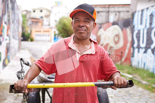 Image of Man, portrait and cart for garbage in street for smile, walk and collect trash for recycling for ecology. Person, rickshaw or barrow for sustainability, environment and nature on road in Sao Paulo