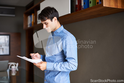 Image of Reading, paperwork and business man in office for proposal, project review and company report. Professional, consultant and person with documents for information, research and planning in workplace