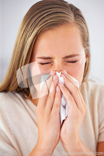 Image of Woman, sneeze and sick with flu or allergies and blowing nose in tissue for healthcare and healing in home. Medical, burnout and care for virus infection or person with sinusitis in apartment