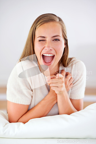 Image of Portrait, wink and woman pointing for choice, motivation and selection in living room. Face, hand gesture and female person for happiness with decision, invitation and resting in lounge of apartment