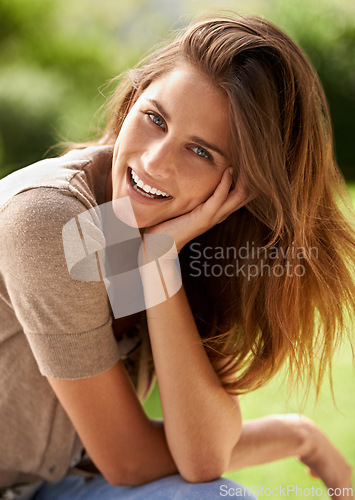 Image of Portrait, woman and smile outdoor in grass, environment and summer to relax in garden, backyard and patio. Female person, gen z girl and happiness for warm weather at park, nature and field