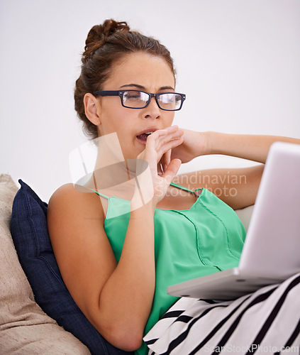 Image of Tired, woman and yawn on sofa laptop or working and exhausted in living room. Female person, casual outfit or computer and glasses in couch or lounge and face expression or sleepy in house or home