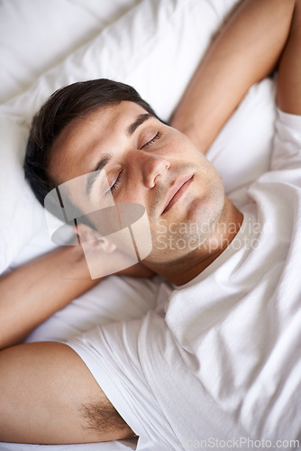 Image of Man, sleep and bed for peace, wellness and rest for indoor in pajamas and bedroom for home and happy. Male person, relax and dreaming at house, calm and tired and eyes closed in top view nap