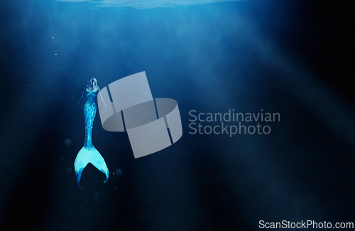 Image of Mermaid, fantasy and underwater with fish woman, siren and scales of sea person. Ocean, mysterious and goddess figure of female creature, aqua and swimming in blue water or surreal artistic illusion