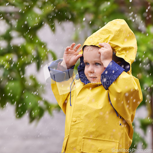 Image of Happy, boy and rain jacket in winter with thinking for carefree, childhood and enjoyment in Germany. Kid, smile and wondering in nature for vacation, weekend or holiday travel in cold weather