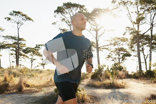 Image of Fitness, running and man on road in forest for health, wellness and strong body development. Workout, exercise and runner on path in nature for marathon training, performance and morning challenge.