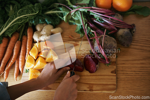 Image of Closeup, kitchen and hands with woman, vegetables and chopping board with knife, home and diet plan. Person, vegan and chef with food or ingredients for lunch and supper with healthy meal or wellness