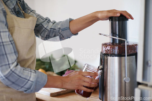 Image of Person, hands and kitchen with juicer, blender or mixer for fruit, smoothie or nutrition at home. Closeup of nutritionist mixing ingredients, vitamins or vegetables in food processor or jar for drink
