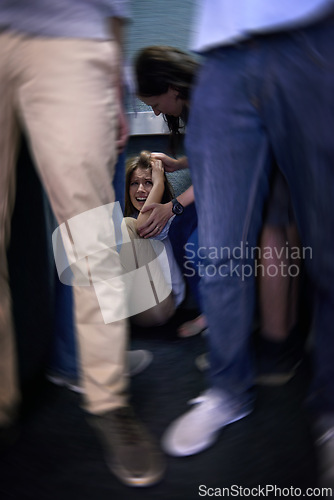 Image of Crowd, female person and fear of social anxiety, screaming or crying in corner. Student, scared or trapped with anthropophobia or stress or worry and woman with hand reaching to help in motion blur