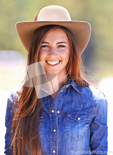 Image of Cowgirl, portrait and hat at farm, smile and western fashion for agriculture, work and outdoor in summer. Woman, person and farmer at ranch for sustainability, countryside and environment in Texas