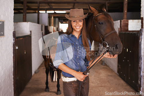 Image of Cowgirl, portrait and happy woman with horse at barn or stable in Texas for recreation. Western hat, person and animal at ranch with pet, livestock or stallion for hobby with care at equestrian farm