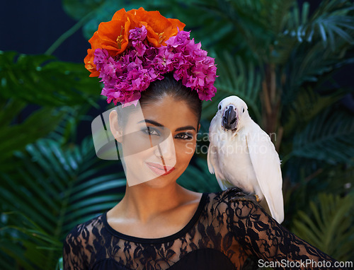 Image of Jungle, portrait or woman with flowers or parrot, natural cosmetics for wellness in nature aesthetic. Smile, animal or female Indian model in rainforest for skincare beauty, pet bird or floral art