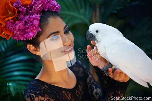 Image of Jungle, bird or woman with flowers or parrot, natural cosmetics for wellness in nature aesthetic. Smile, face or happy female Indian model in rainforest for skincare beauty, pet animal or floral art