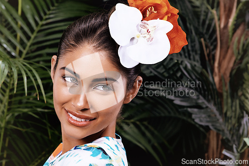 Image of Smile, beauty and woman with flowers in hair at garden, nature or outdoor in India. Face, happy person and floral cosmetics on head, orchid or think of organic makeup on skin with leaves for fashion