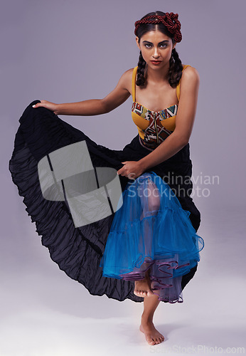 Image of Portrait, flamenco or woman in dress to dance with energy, freedom or fashion for Spanish style. Creative, purple background or artist in studio, tango or performance in musical culture or tradition