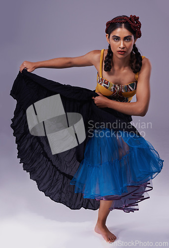 Image of Portrait, flamenco or woman in dress dancing with energy, freedom or fashion for Spanish style. Creative, purple background or artist in studio, tango or performance in musical culture or tradition