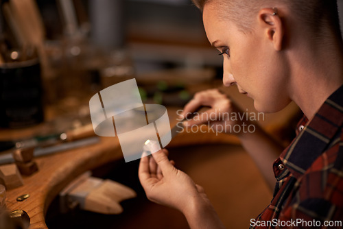 Image of Woodworking, tools and artist in workshop with creative project or sculpture on table at night. Artisan, carpenter and woman with talent for creativity in dark studio in process of carving wood