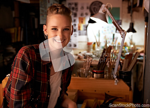 Image of Artist, workshop and portrait of happy woman in studio to work on creative sculpture or project at night. Artisan, workplace or person with pride or confidence as carpenter with talent and tools