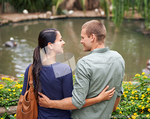 Image of Couple, hug and love or together at zoo, relationship and care on outdoor adventure or holiday. People, back and embrace on vacation and romance at sanctuary, date and calm or peace on weekend trip