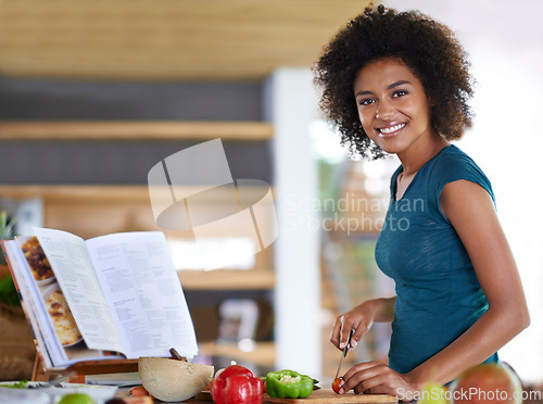 Image of Cooking, portrait and happy woman cutting vegetables with recipe book in kitchen for healthy diet, nutrition or lunch. Chopping board, food or face of African person preparing organic meal in home