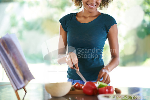 Image of Cooking, smile and hands cutting vegetables in kitchen for healthy diet, nutrition or lunch. Chopping board, food and happy person preparing salad for dinner or organic meal with recipe book in home