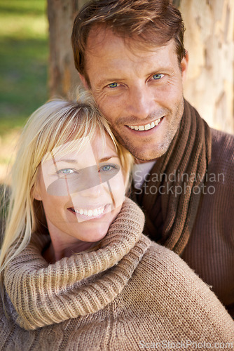 Image of Couple, park and portrait by tree in embrace, romance and bonding for love at park on weekend. People, care and outdoor date for relationship or marriage, support and hug in nature for commitment