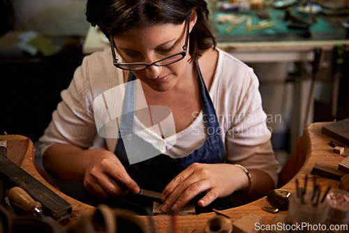 Image of Carving, wood and artist with tools in workshop for creative project or production of sculpture on table. Artisan, carpenter and woman with talent for creativity in studio in process of woodworking