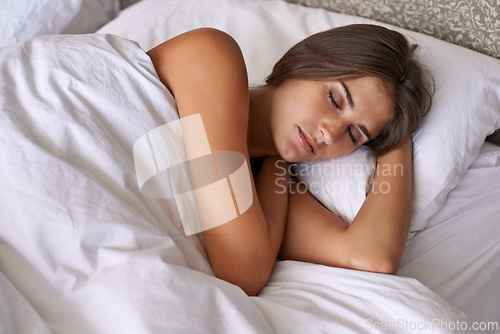 Image of Woman, wellness and sleeping in bed at home, health and peace rest on soft pillow on comfortable mattress. Tired person, dream or relax in bedroom for stress relief, fatigue or weekend in cozy house