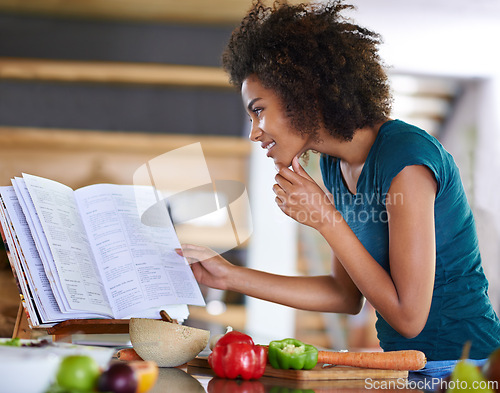 Image of Cooking, happy woman and reading recipe book in kitchen for healthy diet, nutrition or lunch. Smile, food and African person with cookbook for preparing vegetables, dinner and organic meal in home