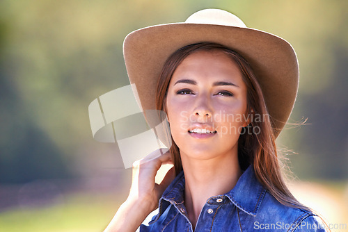 Image of Cowgirl, portrait and hat at farm, nature and western fashion for agriculture, work and outdoor in summer. Woman, person or farmer at ranch for sustainability, countryside and environment in Texas